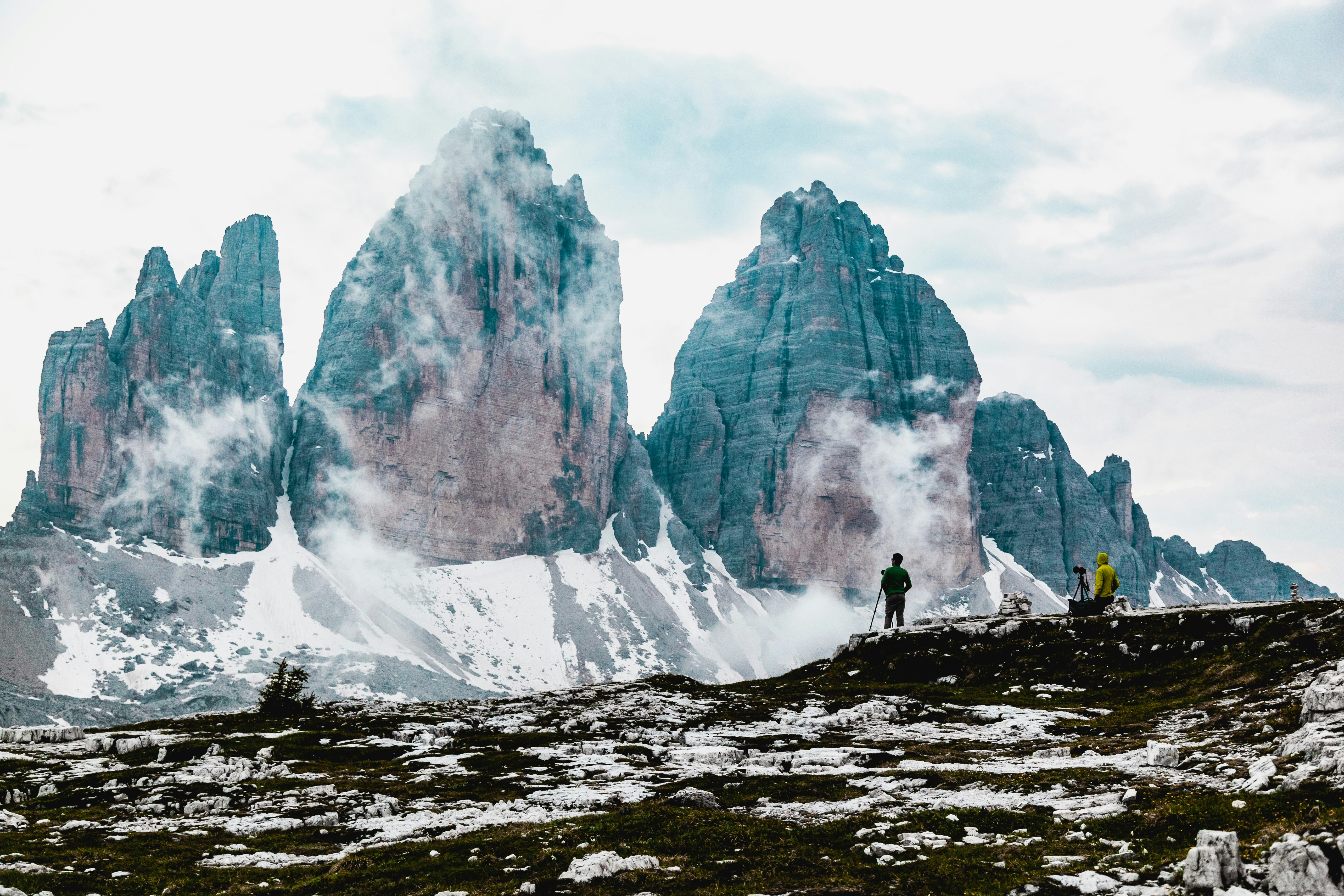 person standing on rocky mountain during daytime