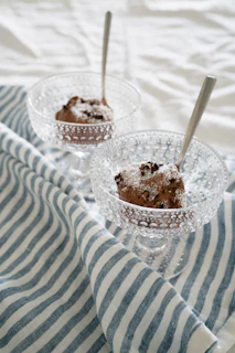 A vibrant shot of Edo’s signature ramen bowl steaming alongside a decadent Godiva chocolate dessert.