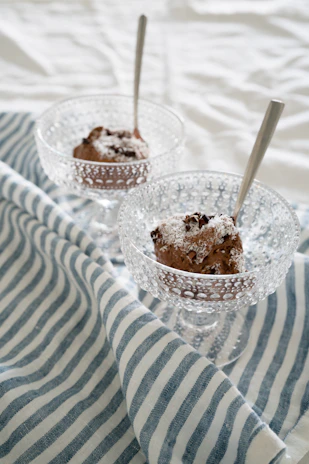 A vibrant shot of Edo’s signature ramen bowl steaming alongside a decadent Godiva chocolate dessert.