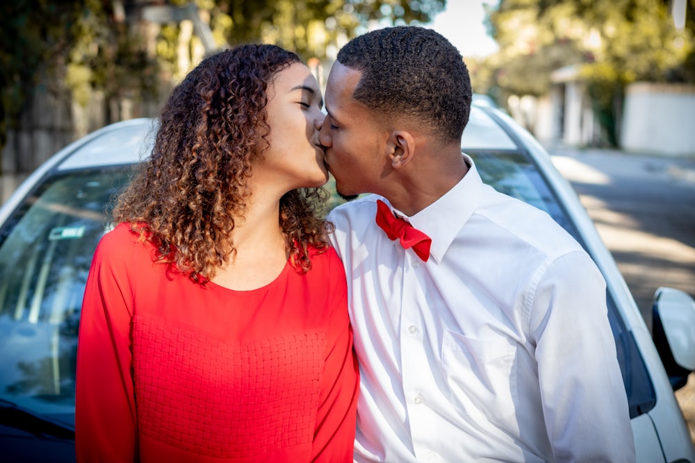 man in white dress shirt kissing woman in red tank top photo – Free Tie  Image on Unsplash