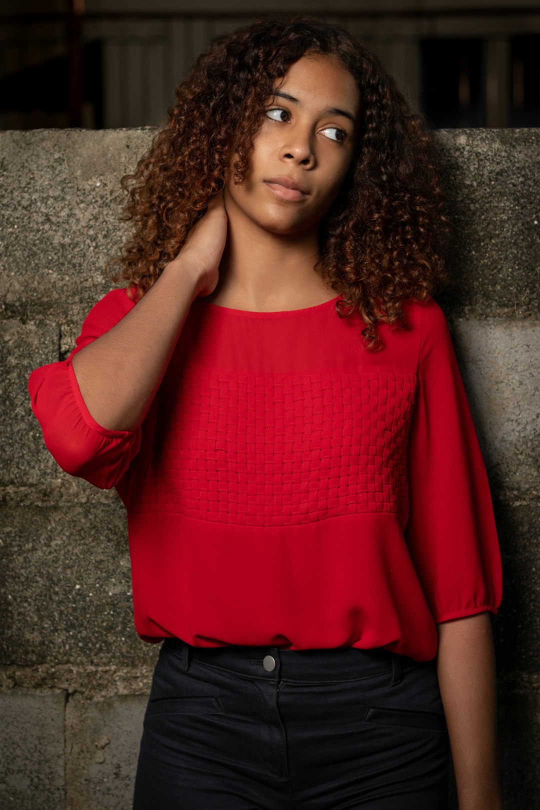 woman in red scoop neck long sleeve shirt and black skirt