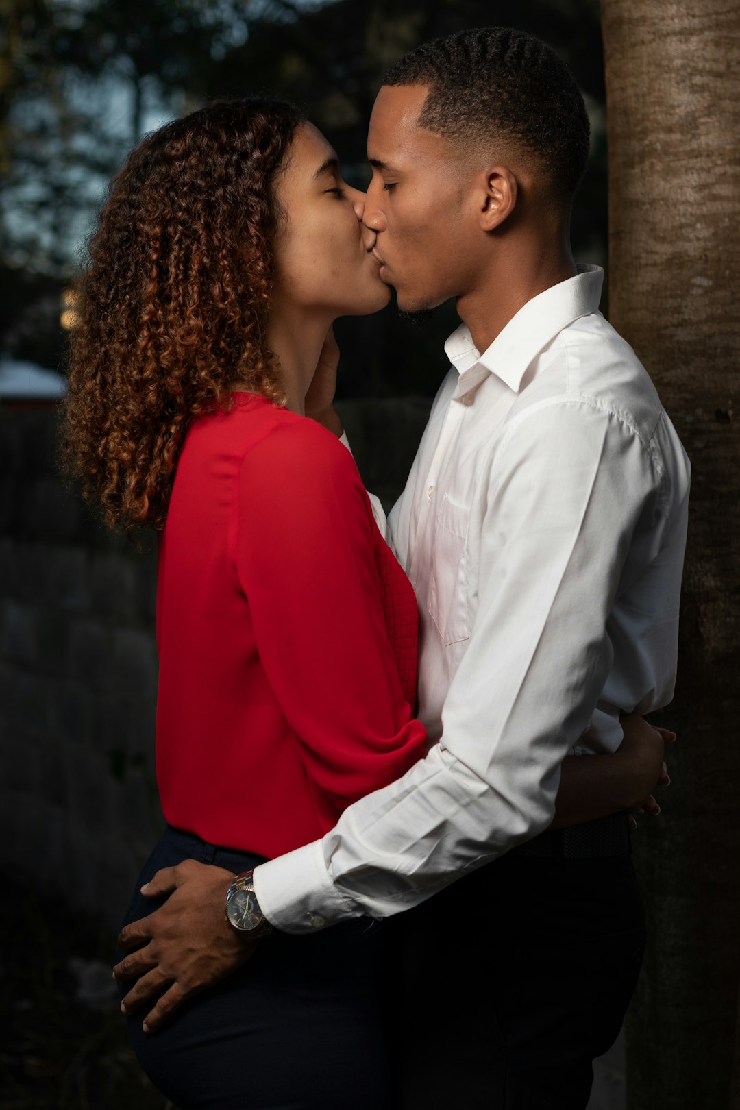 man in white dress shirt and woman in red blazer