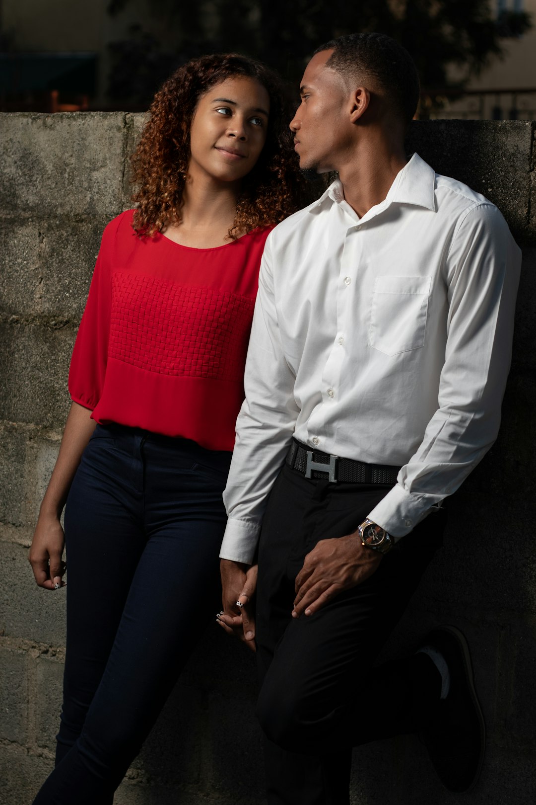 man in white dress shirt beside woman in red dress shirt