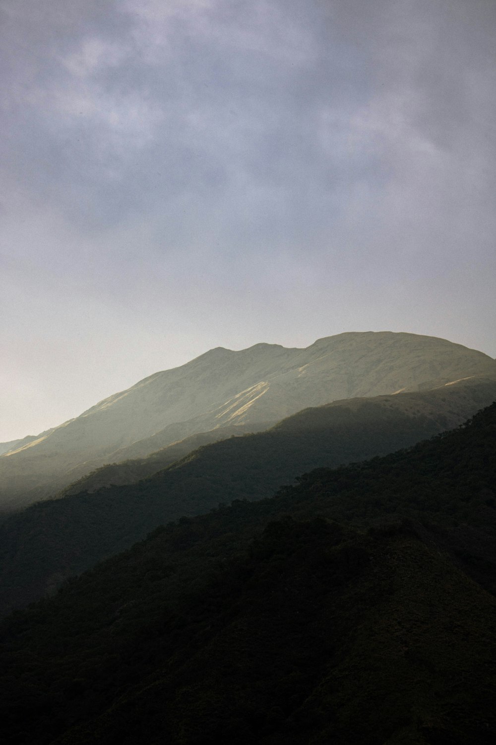 green and brown mountains under white clouds during daytime