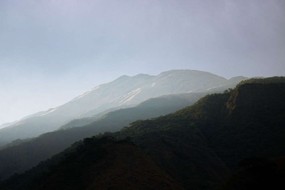 green and brown mountains under white sky during daytime