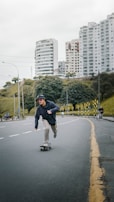Young man skateboarding in urban park, dressed in comfortable and stylish El Abem streetwear.
