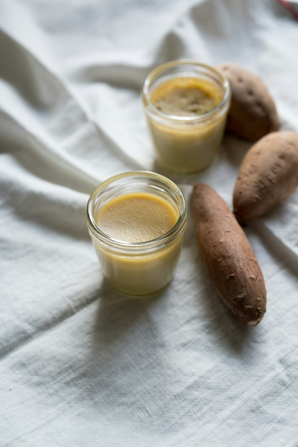 brown sausage beside clear drinking glass with milk