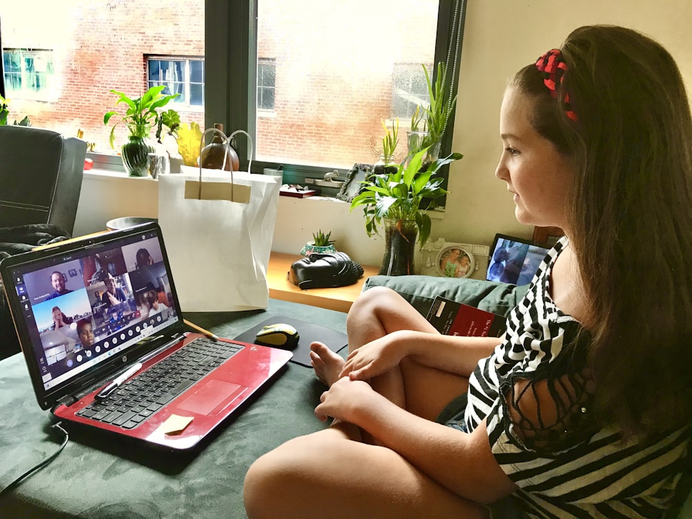 woman in black and white zebra print shirt using macbook pro