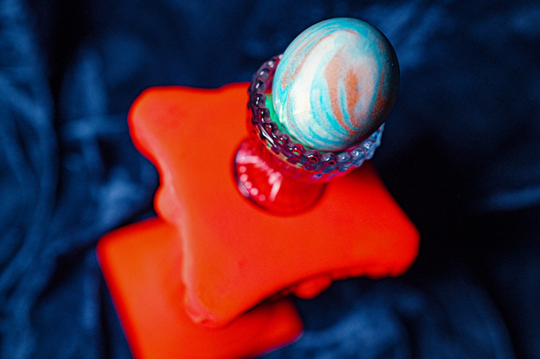 silver and gold ring on orange surface