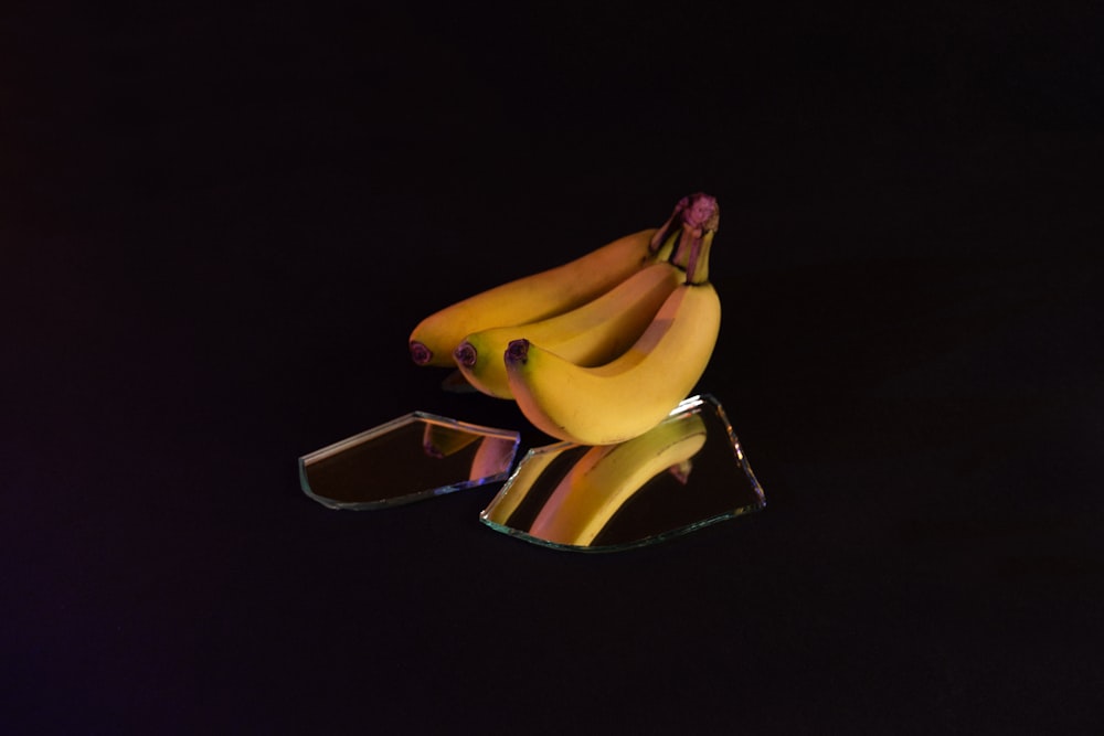 3 yellow banana on black background