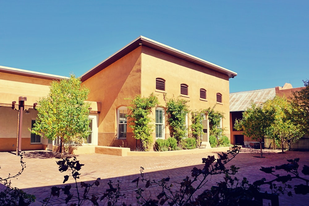 brown concrete building near green trees during daytime