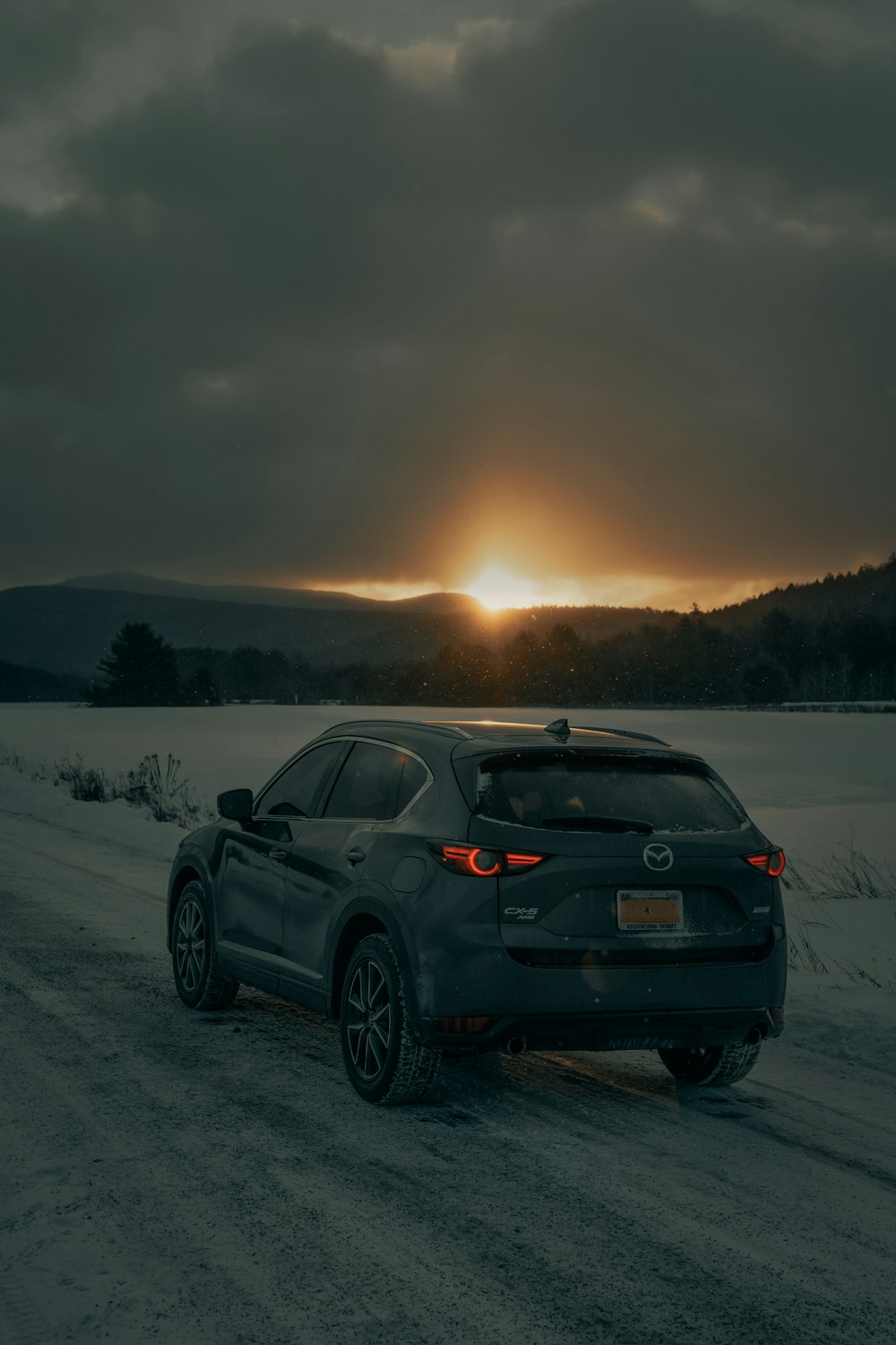 BMW negro x 6 en un campo cubierto de nieve durante el día