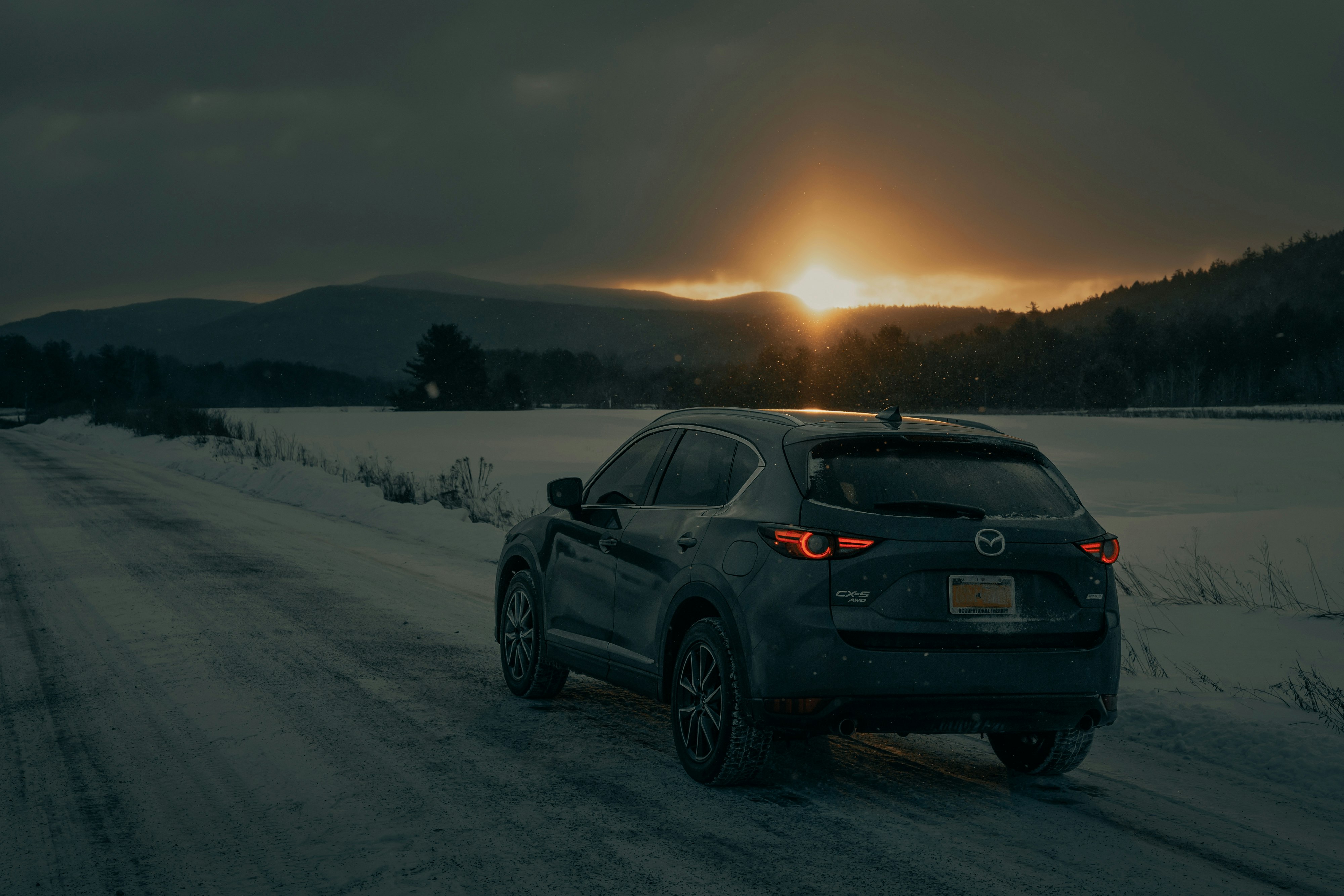 black bmw x 6 on snow covered field during daytime