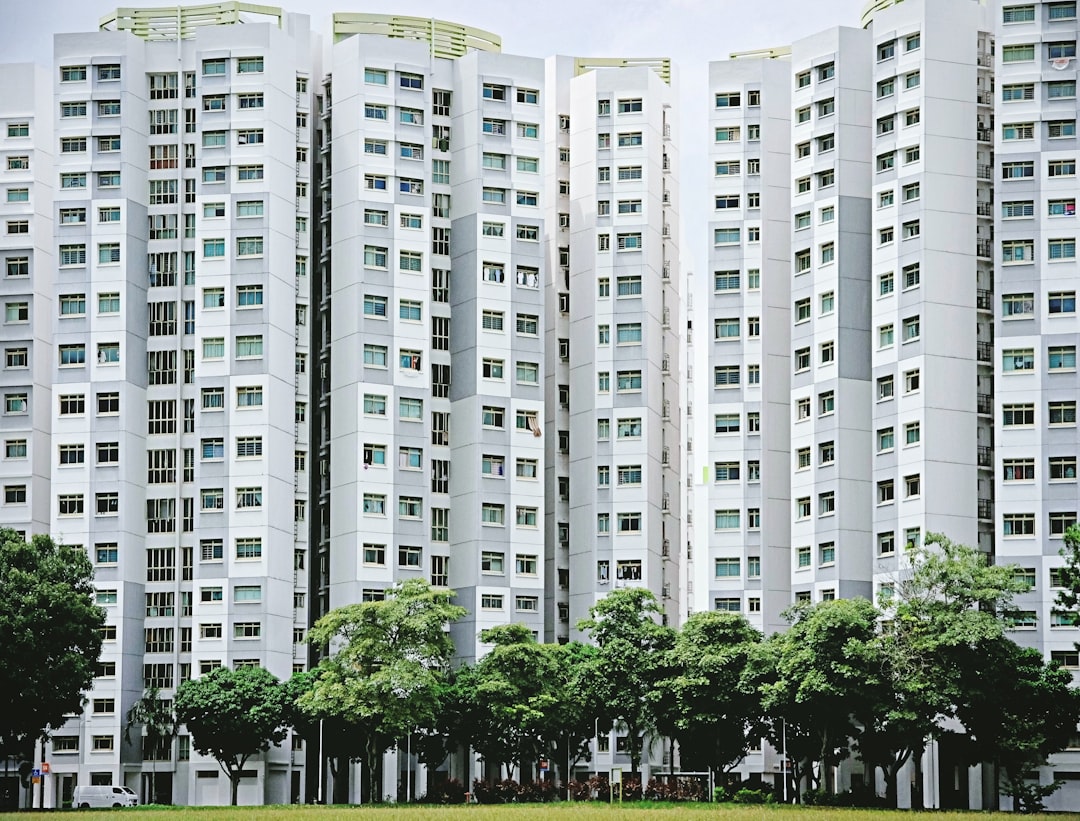 white concrete building near green trees during daytime