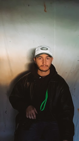 A close-up shot of a neon green crypto cartel hoodie draped over a sleek black chair under moody lighting.