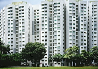 white concrete building near green trees during daytime