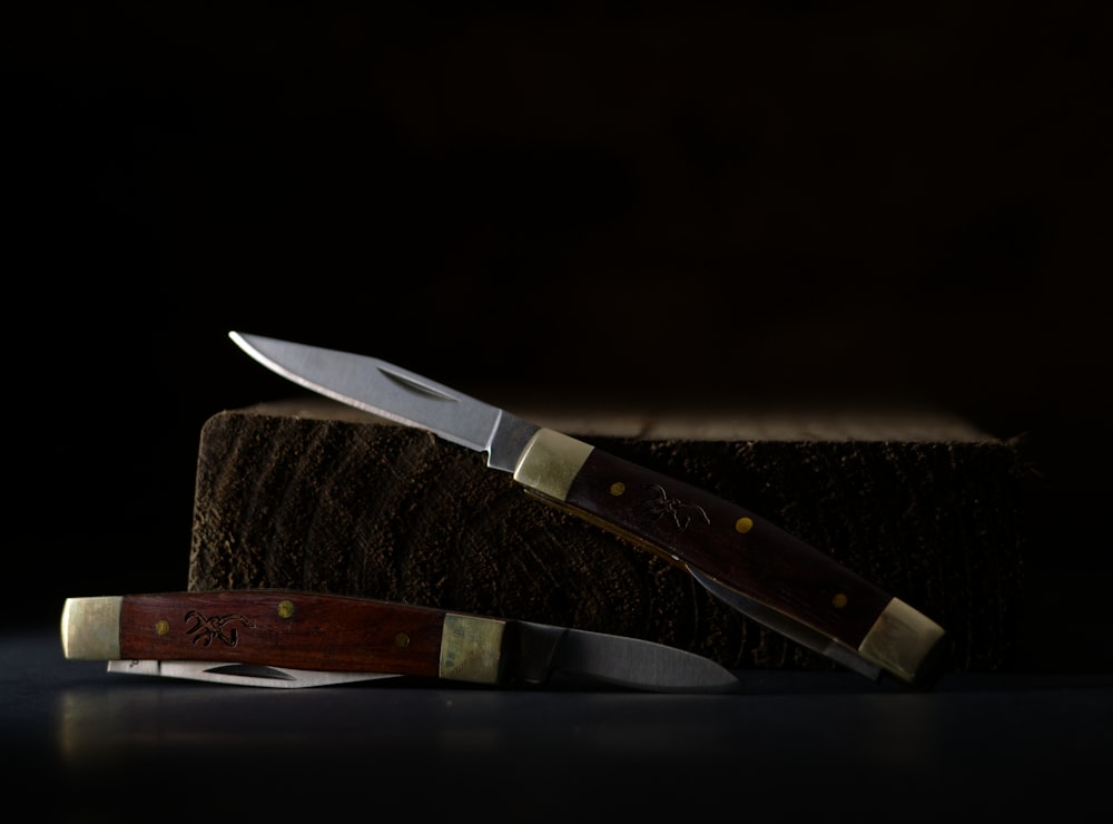 brown handle knife on brown wooden chopping board