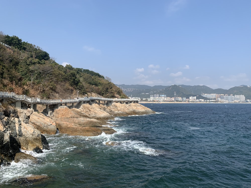 body of water near mountain during daytime