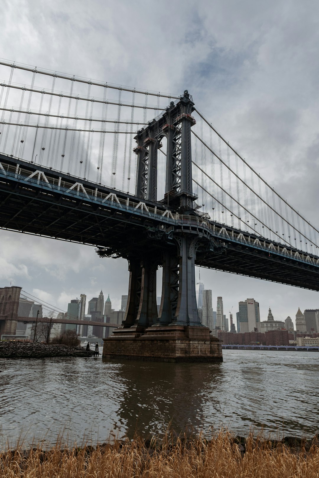 brown and black bridge under white sky during daytime