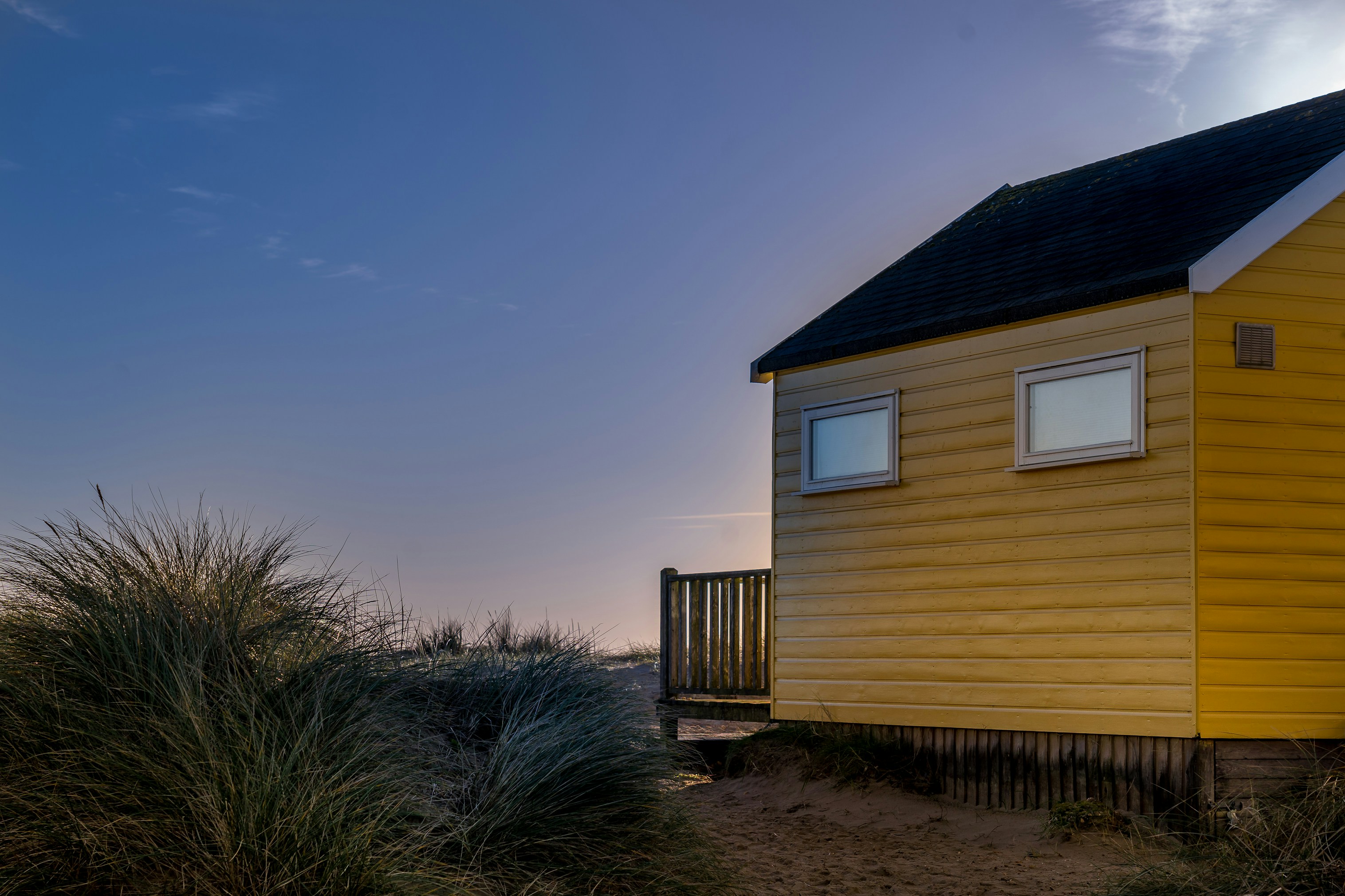 yellow and black wooden house under blue sky during daytime