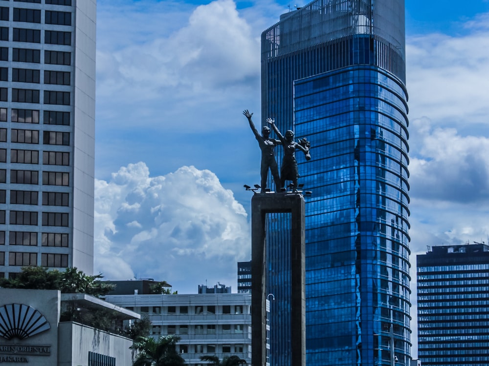black statue of man riding on horse under blue and white cloudy sky during daytime
