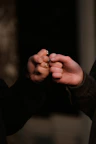 person holding gold ring in dark room