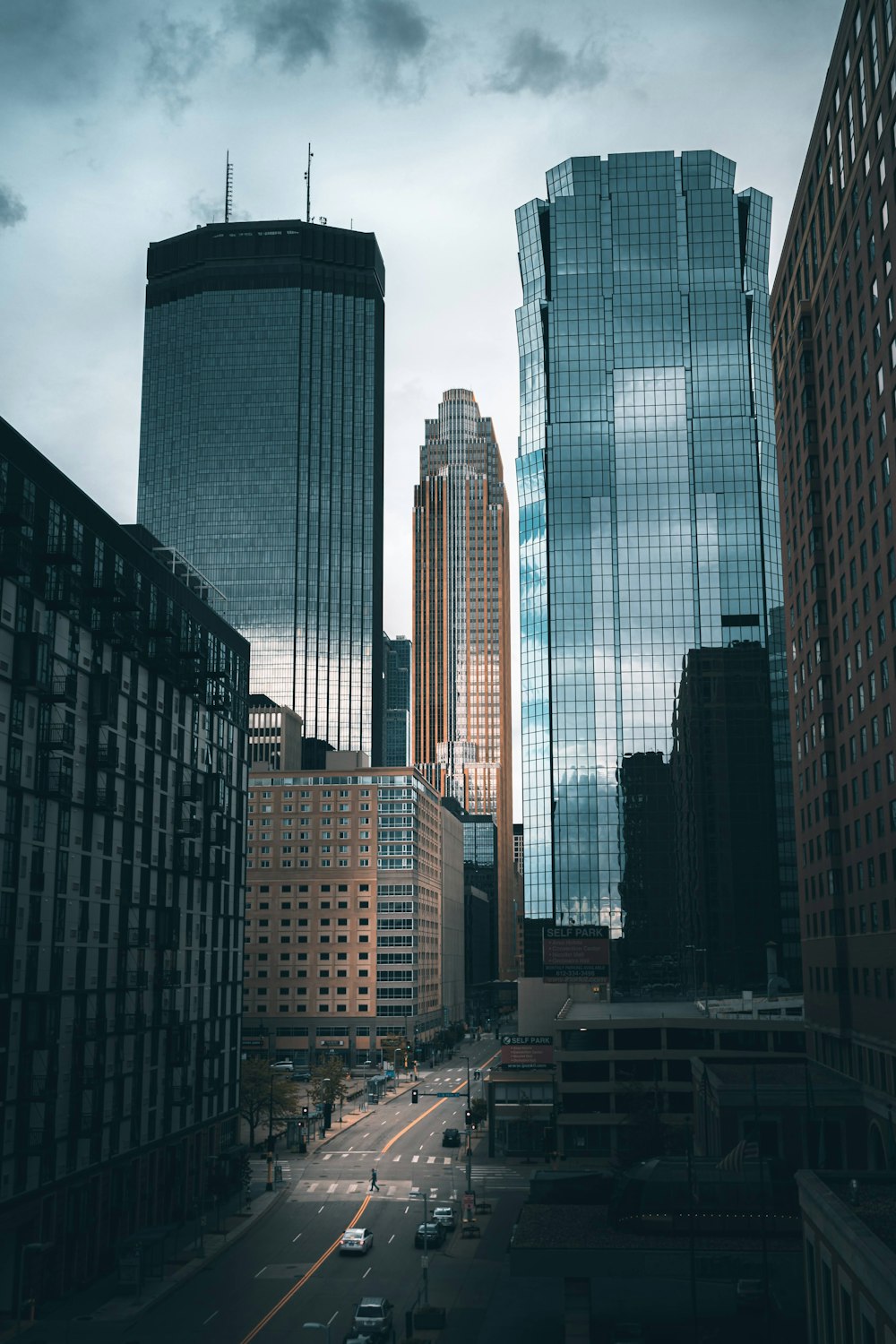 high rise buildings under white clouds during daytime