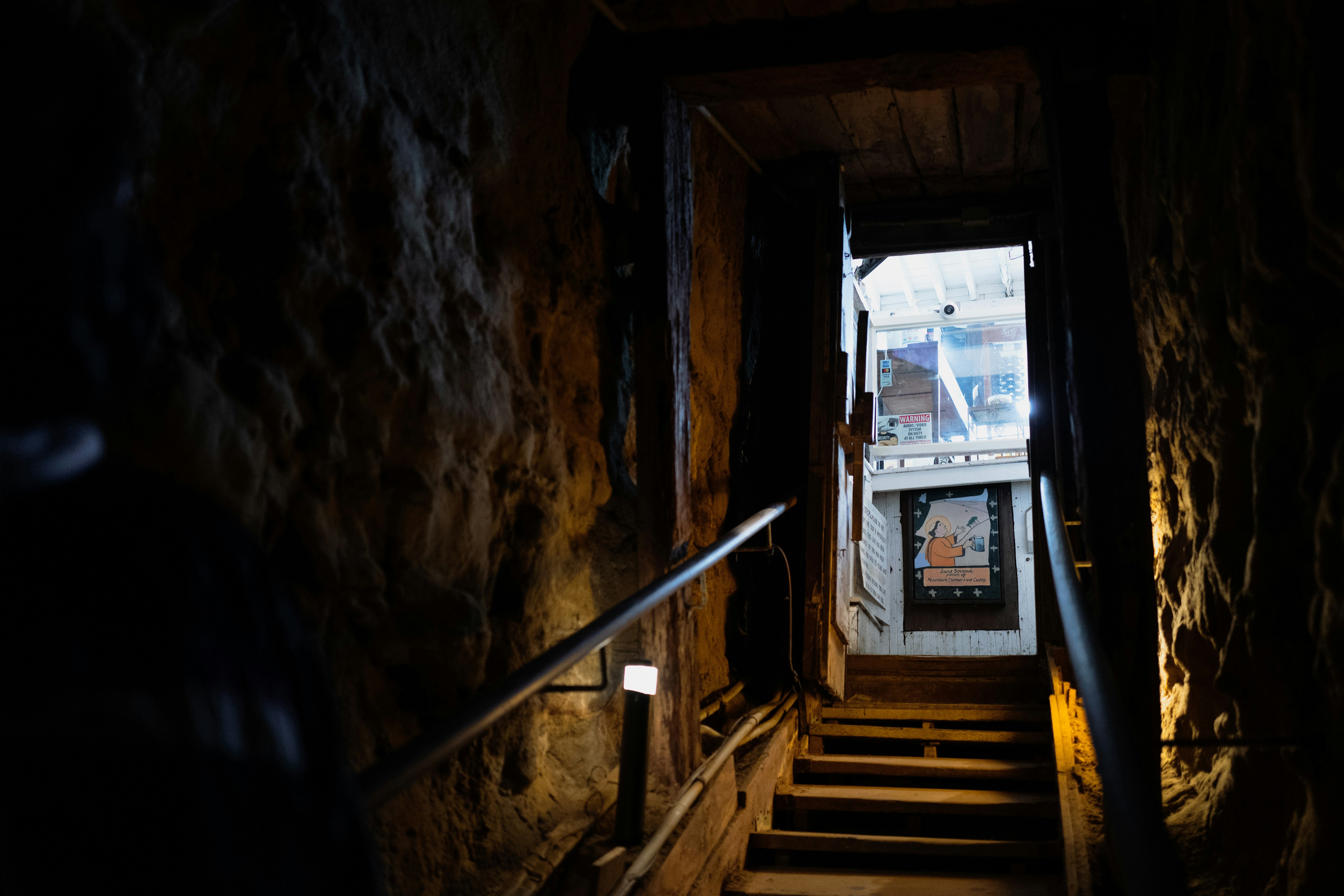 brown wooden staircase near brown wooden door