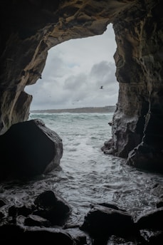 brown rock formation on sea during daytime