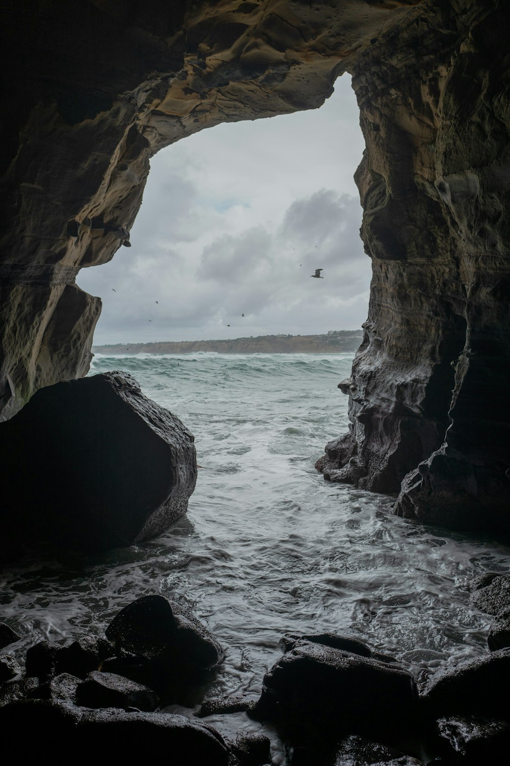 brown rock formation on sea during daytime