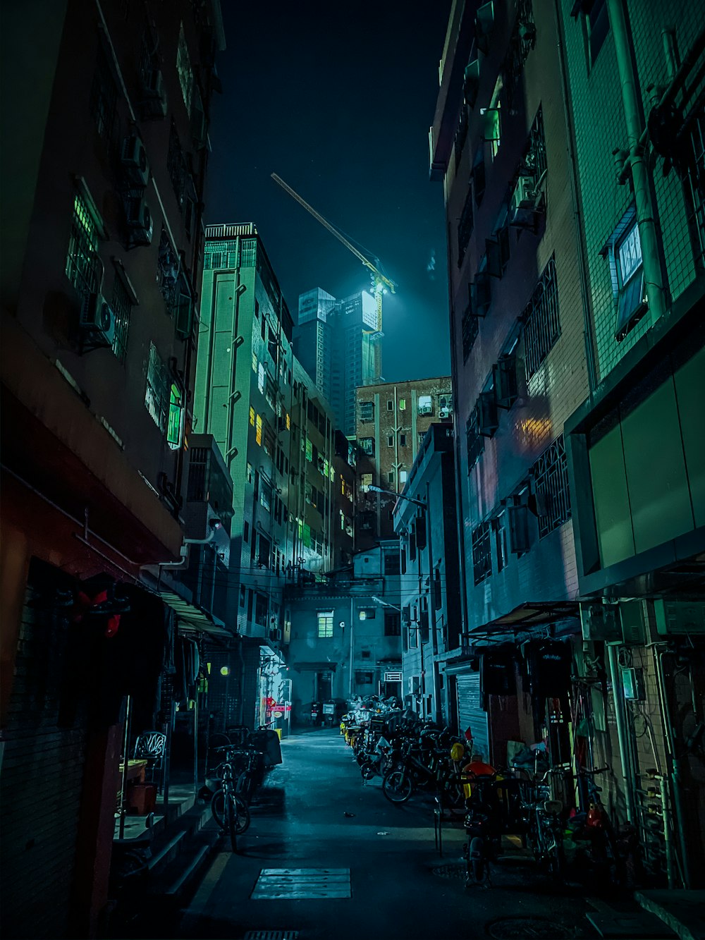 people walking on street between high rise buildings during night time