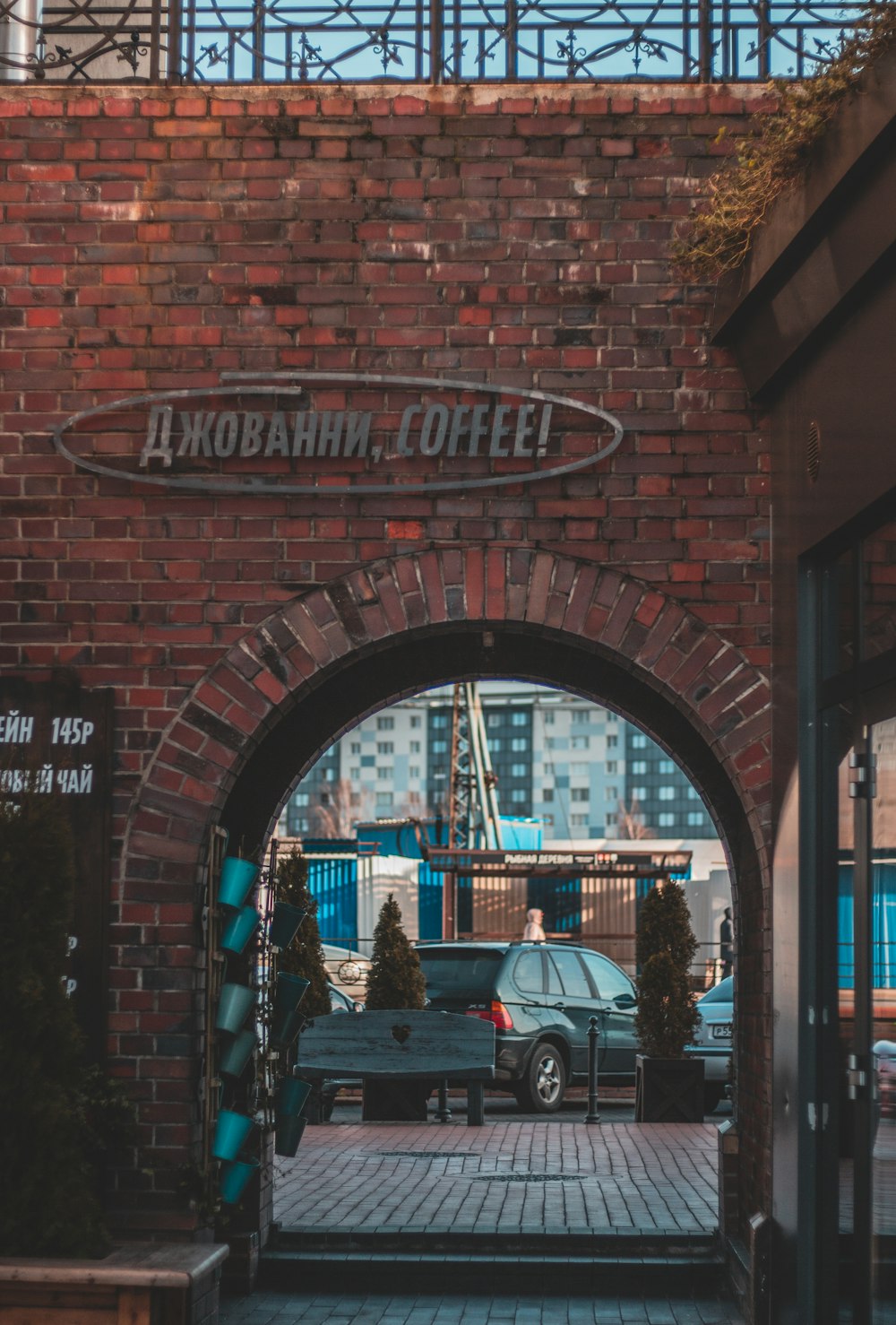 cars parked in front of brown brick building