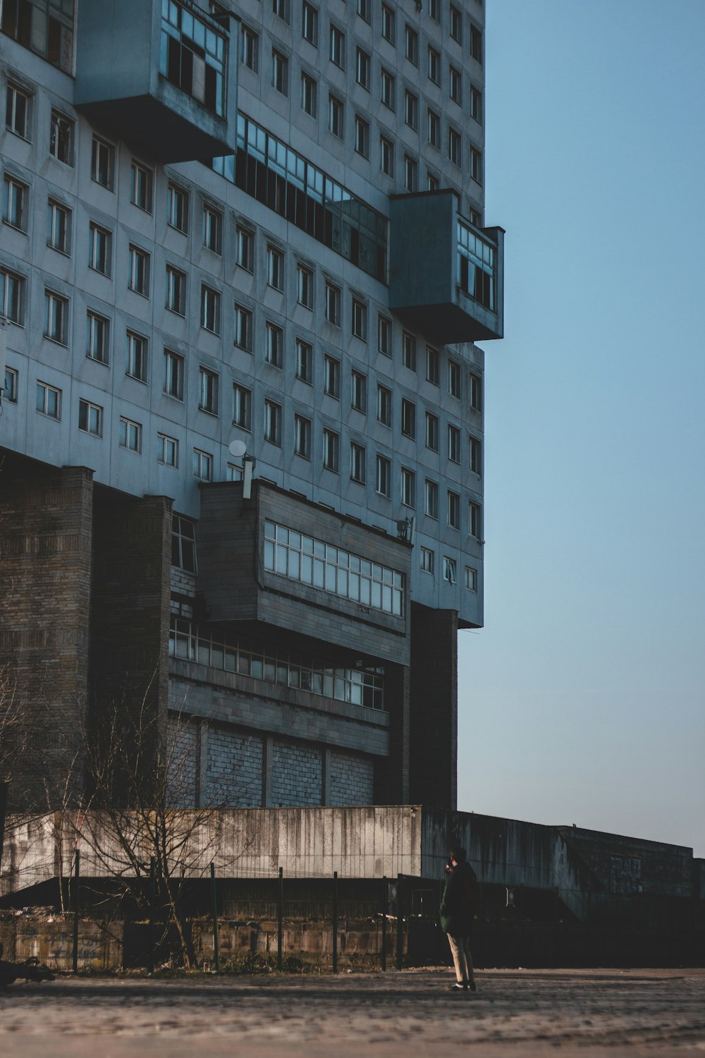 a tall building sitting next to a parking lot