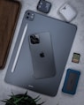 silver ipad on brown wooden table