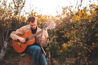 Happy student holding a guitar after a successful guitar lesson