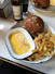 Close-up of a delicious plate of pub food with a cold drink on the side.
