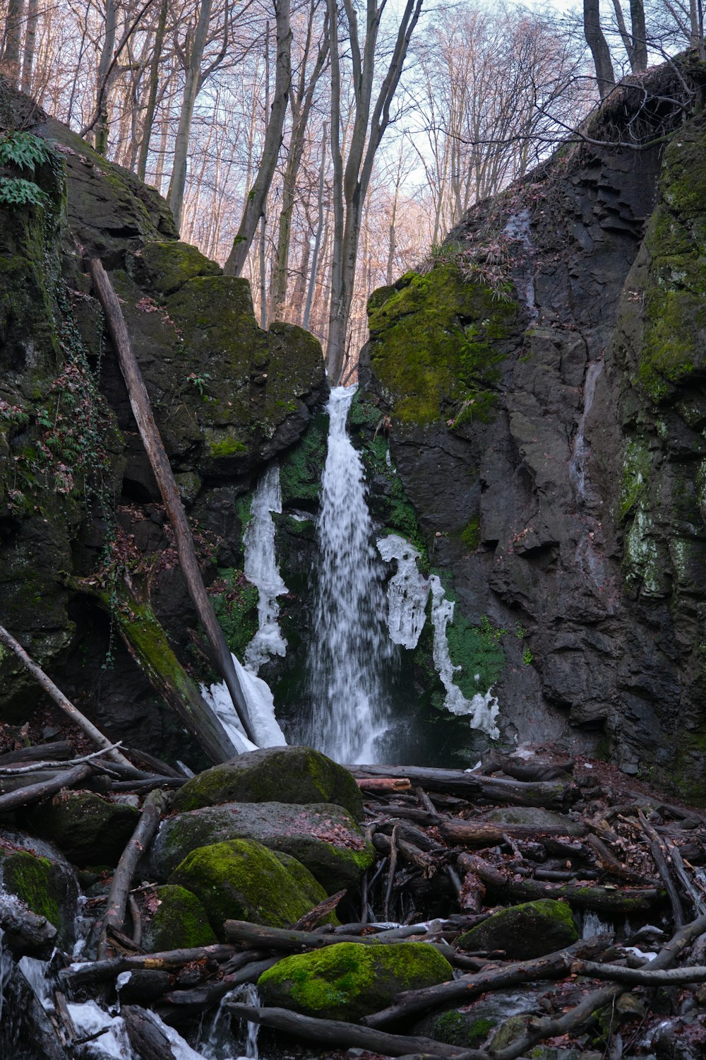 water falls in the middle of rocky mountain