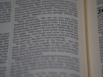 A close-up view of a page from a Bible, with text detailing a passage from the Book of Judges. The focus is on verses discussing a journey from Bethlehem in Judah.