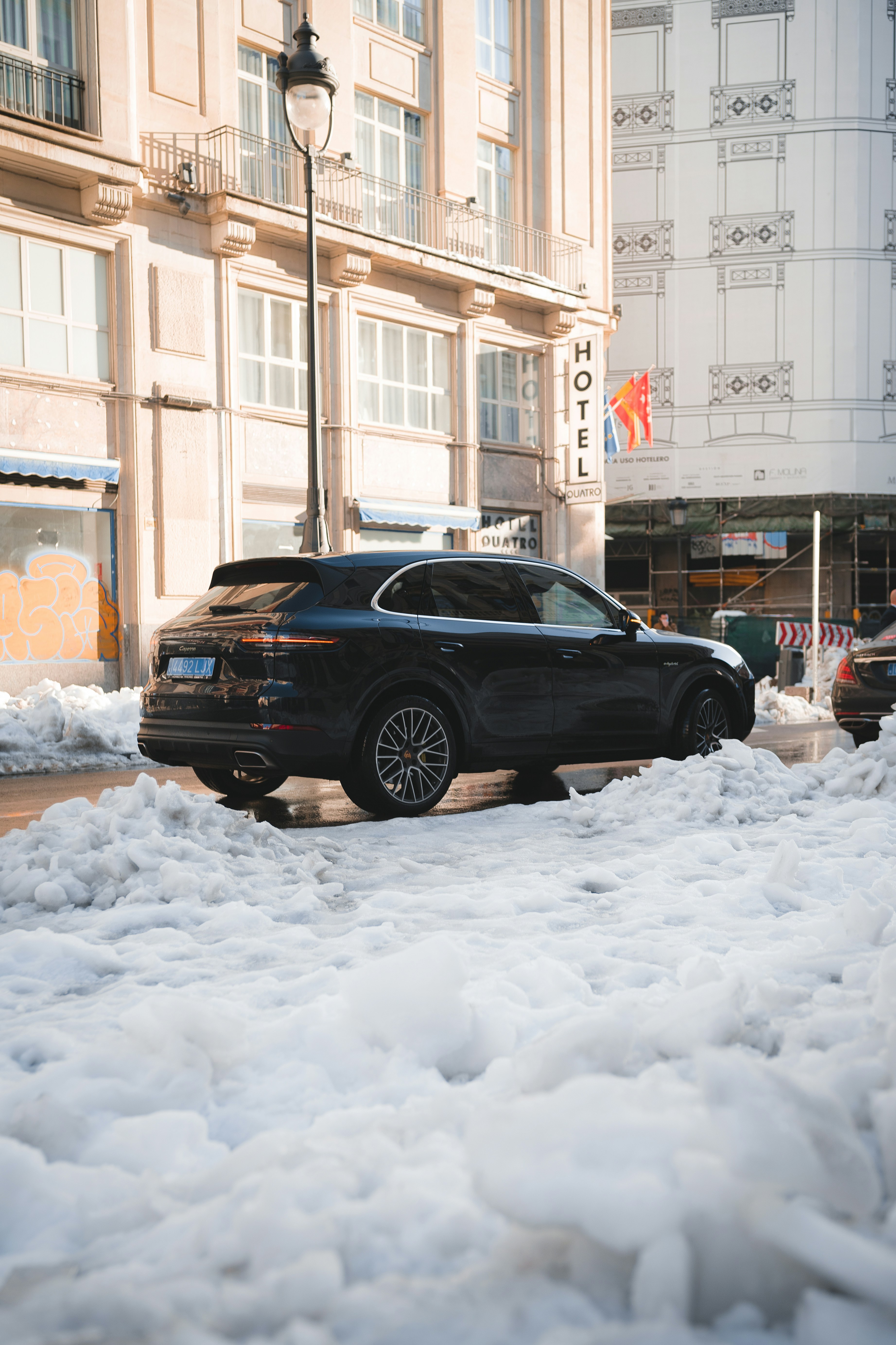 black suv on snow covered road during daytime