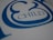A close-up view of stylized blue text on a white surface, featuring the word 'CHILD' with decorative elements surrounding it.