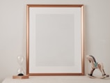 white wooden framed mirror on brown wooden table