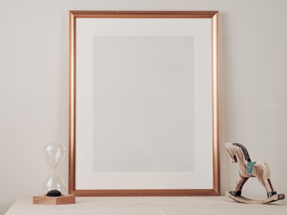 Miroir encadré en bois blanc sur table en bois marron