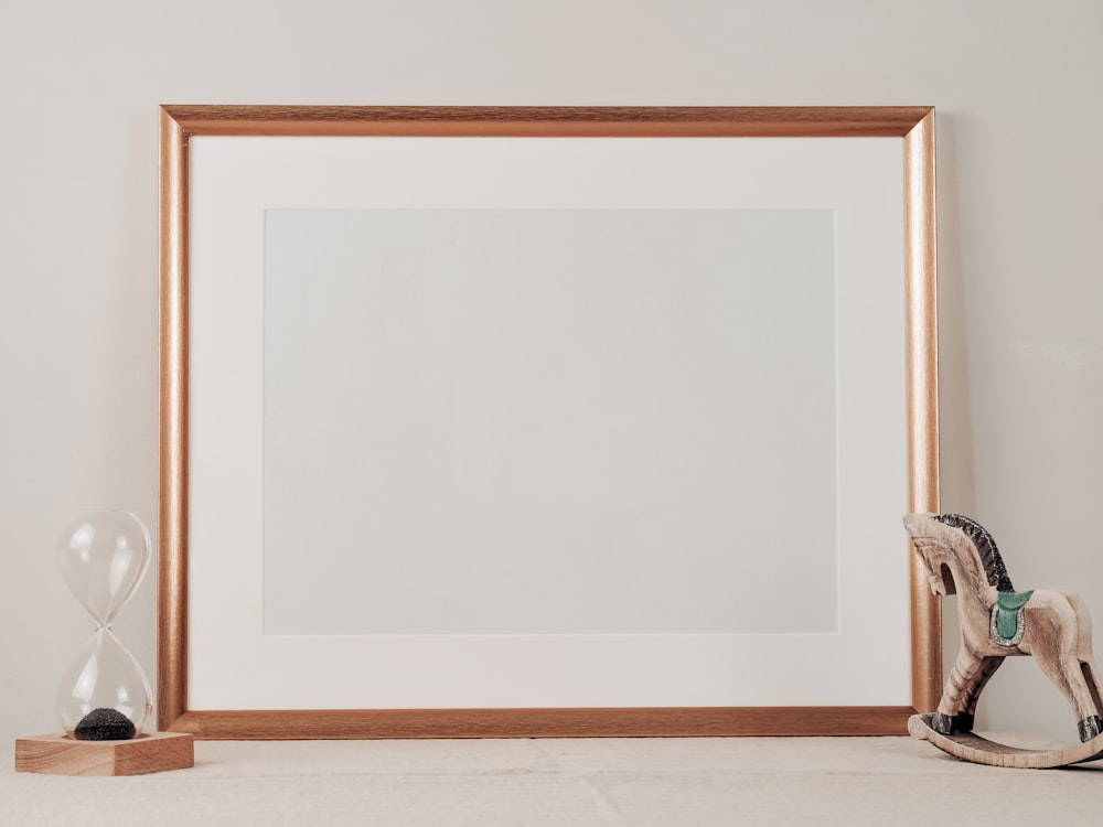 brown wooden frame on white wall