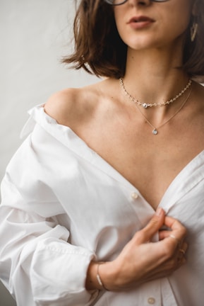 woman in white dress shirt wearing silver necklace