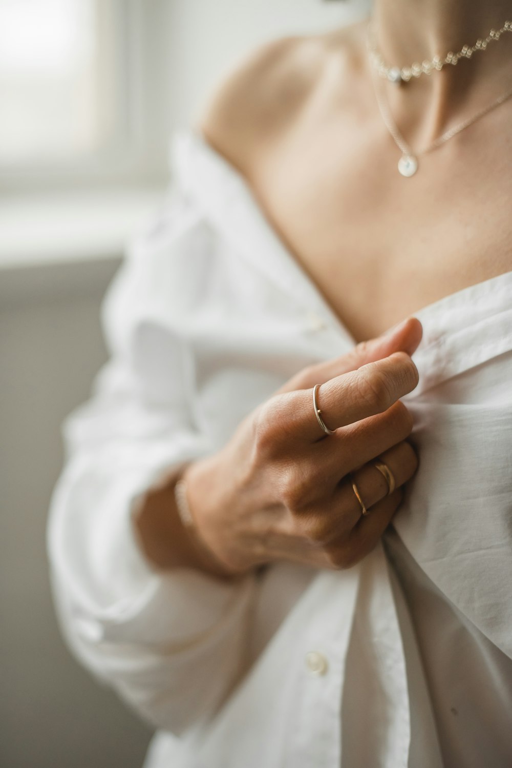 woman in white dress wearing gold ring