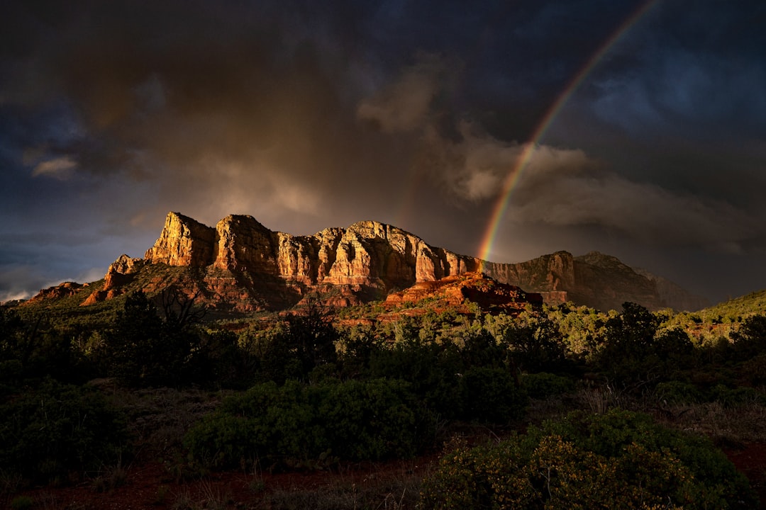 brown rocky mountain under gray sky