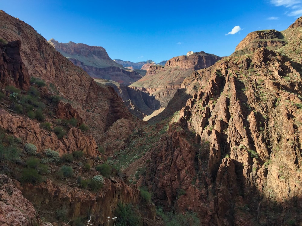 brown and green mountains under blue sky during daytime