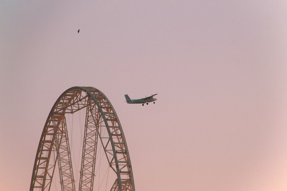 white airplane flying over the sky during daytime