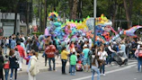 A bustling crowd admiring sculptures and installations at an outdoor heritage event.