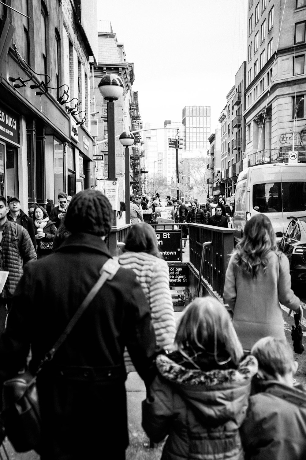 grayscale photo of people walking on street